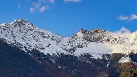 innsbruck austria capital tyrol tyrolean alps nordkette larwendel mountain snowy peaks range kleiner solstein sunny blue sky sunset fog october november autumn fall static shot