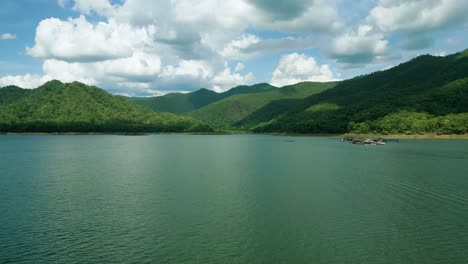 4k cinematic nature aerial footage of a drone flying over the beautiful lake and mountains of srilanna national park in chiang mai, thailand on a sunny day