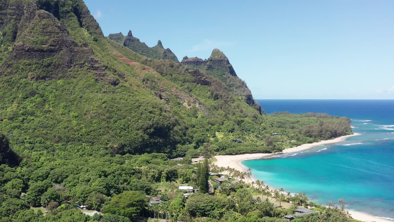 Aerial wide push-in shot of the Maniniholo Dry Cave along the coast of Haena, Kaua'i
