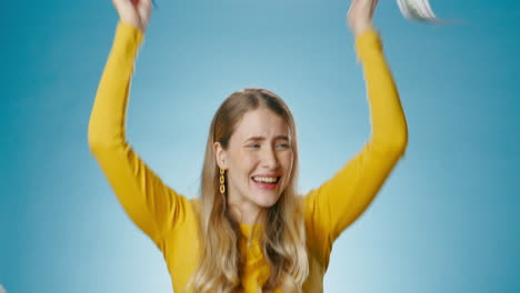 excited woman celebrating financial success with money