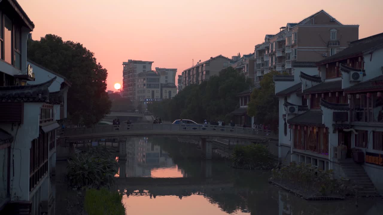Establishing shot of Zhujiajiao Water Town bridge in Shanghai, China at sunset