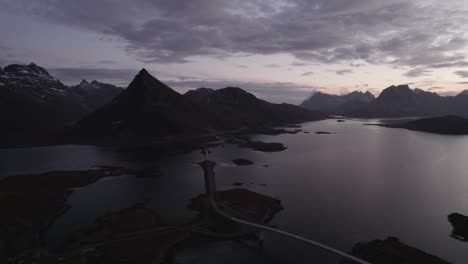 Aerial-view-overlooking-the-Fredvang-bridges,-dusk-in-Lofoten,-Norway---pan,-drone-shot