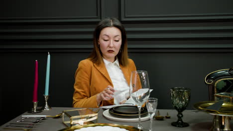 asian woman sitting at elegant table