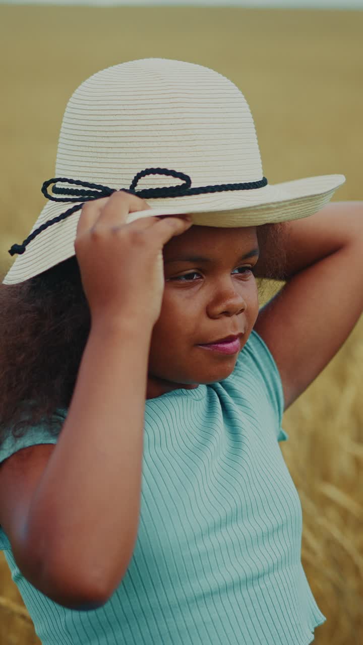 Young Girl in a Straw Hat in a Wheat Field
