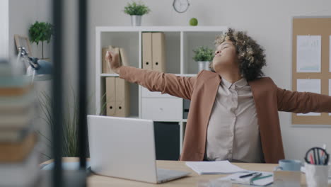 woman adjusting jacket in office
