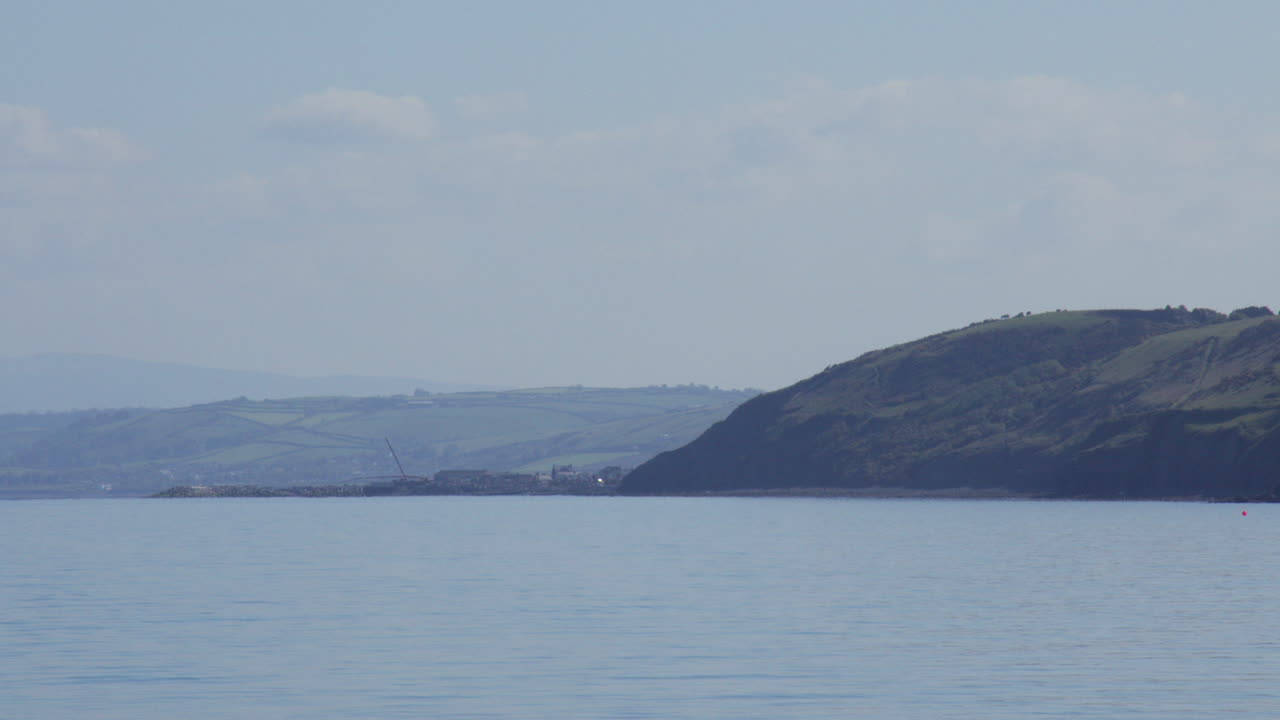 Long shot looking east up Cardigan Bay at new quay beach