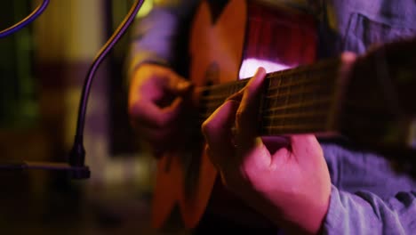 man playing guitar in a music studio