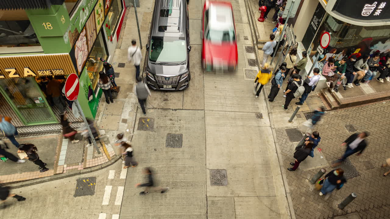 HONG KONG - 19 MARCH 2025 : Timelapse looking down onto a street scene in Hong Kong Central