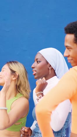 Group of happy multi-ethnic people dancing together outdoors