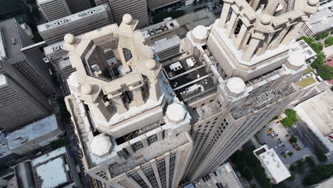 high angle view of tall business skyscraper with pair of rooftop crowns