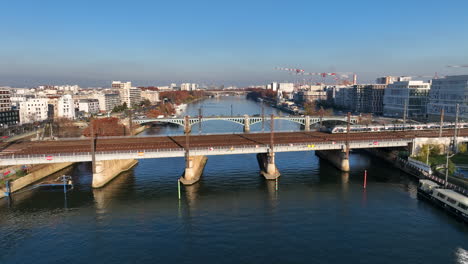 local train crossing the river seine aerial shot in paris france pollution blue