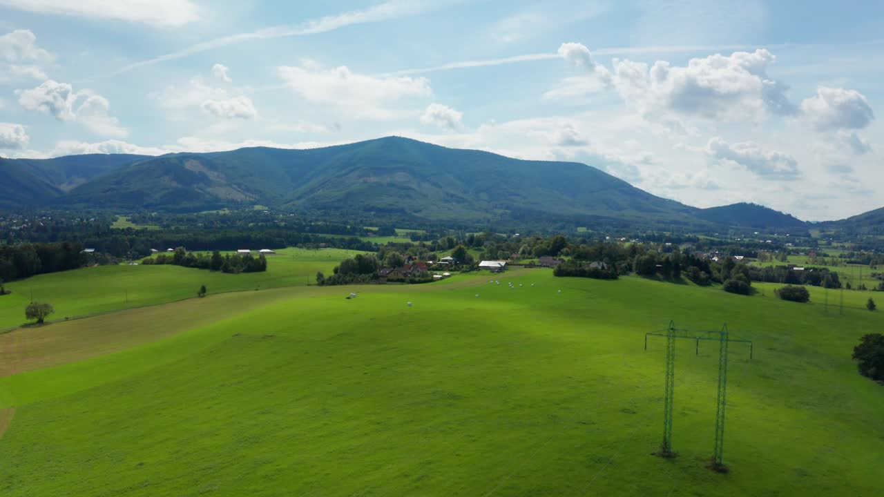 Dolly drone shot of czech small village and field with beskydy mountains