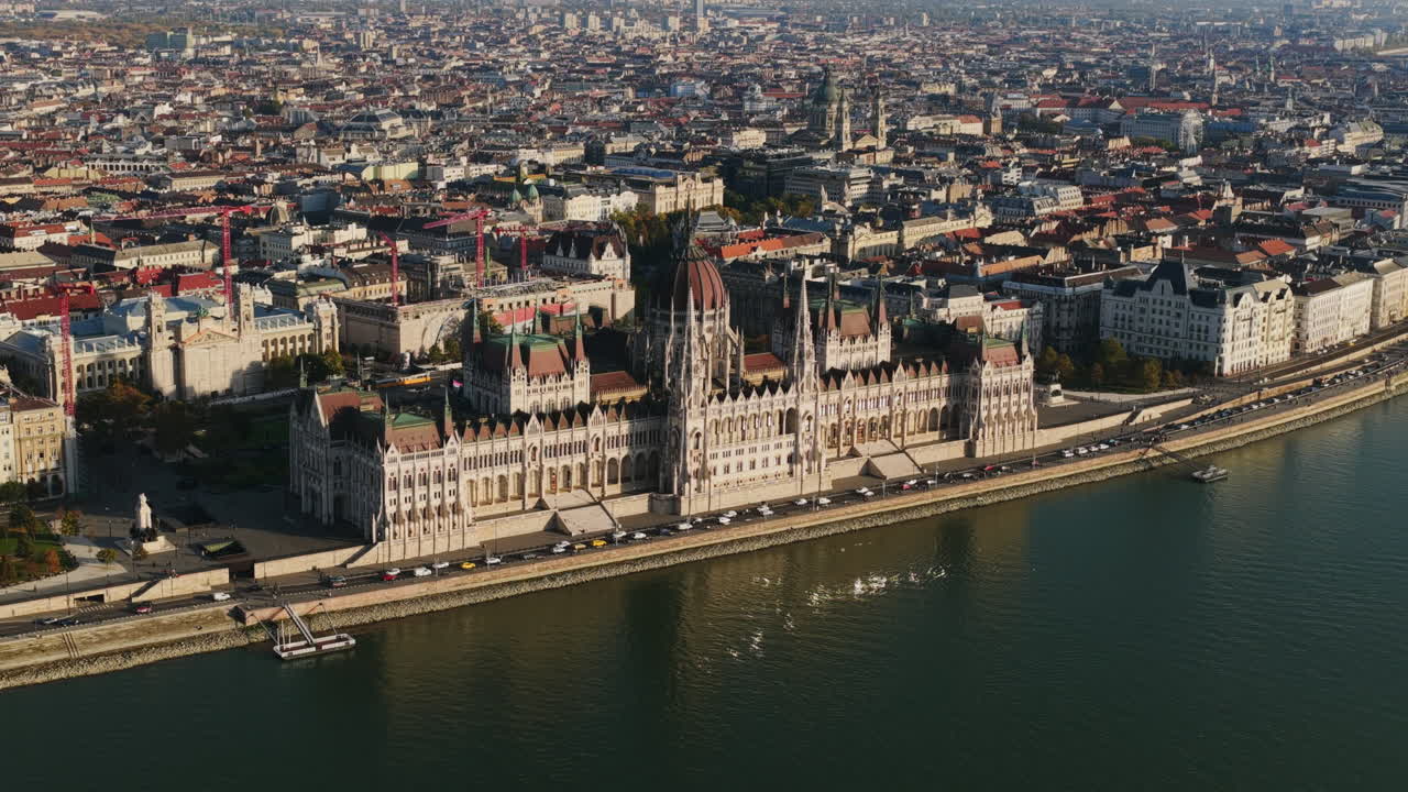 Majestic aerial view of the Hungarian Parliament building with its Gothic Revival architecture shining along the Danube River in Budapest
