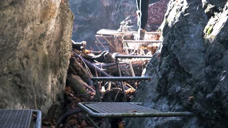 Close-handheld-shot-of-a-woman-walking-on-metallic-stair-in-National-Park-of-Slovakia