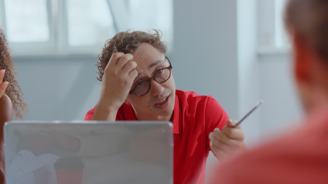 un joven empresario hablando con sus colegas de oficina, un tipo creativo discutiendo con sus socios.