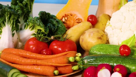 assorted vegetables arranged against a blue background