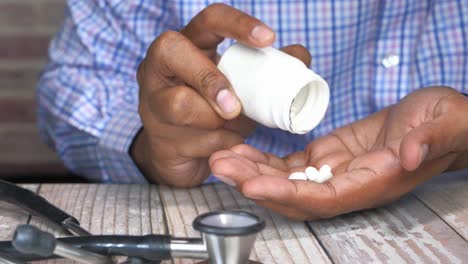 doctor pouring pills into hand.