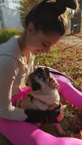 woman and pug in autumn park