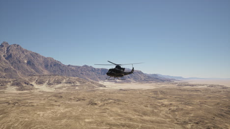 military helicopter flying over desert