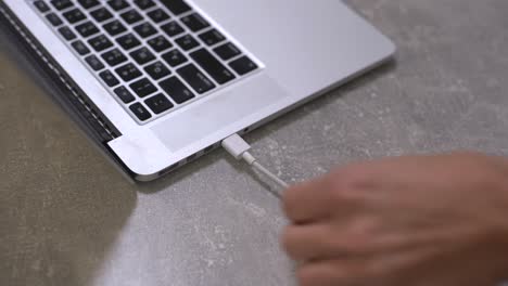 Hand-connecting-usb-hard-drive-to-laptop,-modern-personal-computer-technology