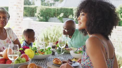 Video-of-african-american-family-spending-time-together-and-having-dinner-outside