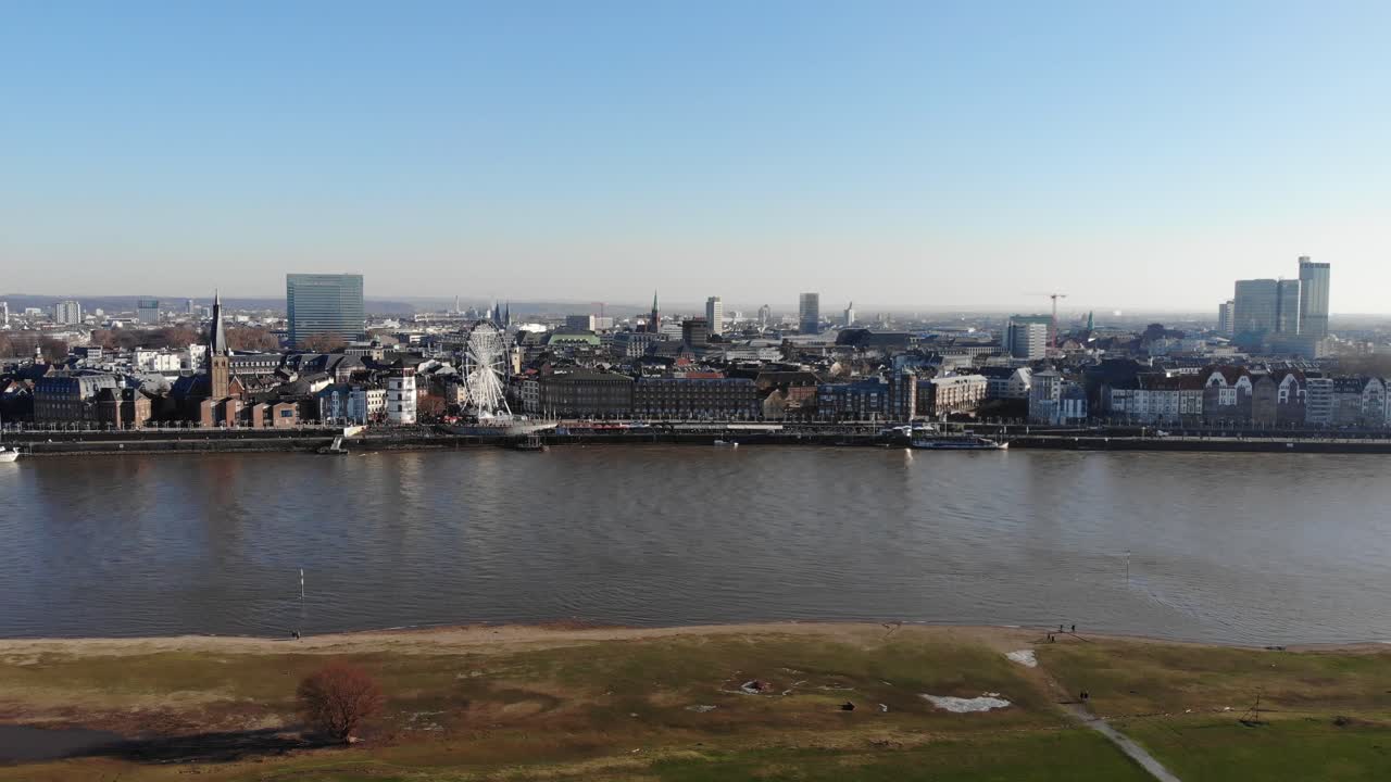 Drone Footage of Duesseldorf Altstadt Skyline over the river rhine, city center, in sunny winter weather, rising up