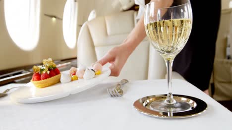 flight attendant serving sweet food in private jet 4k