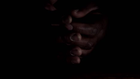 man-praying-to-god-with-hands-together-Caribbean-man-praying-with-black-background-stock-footage