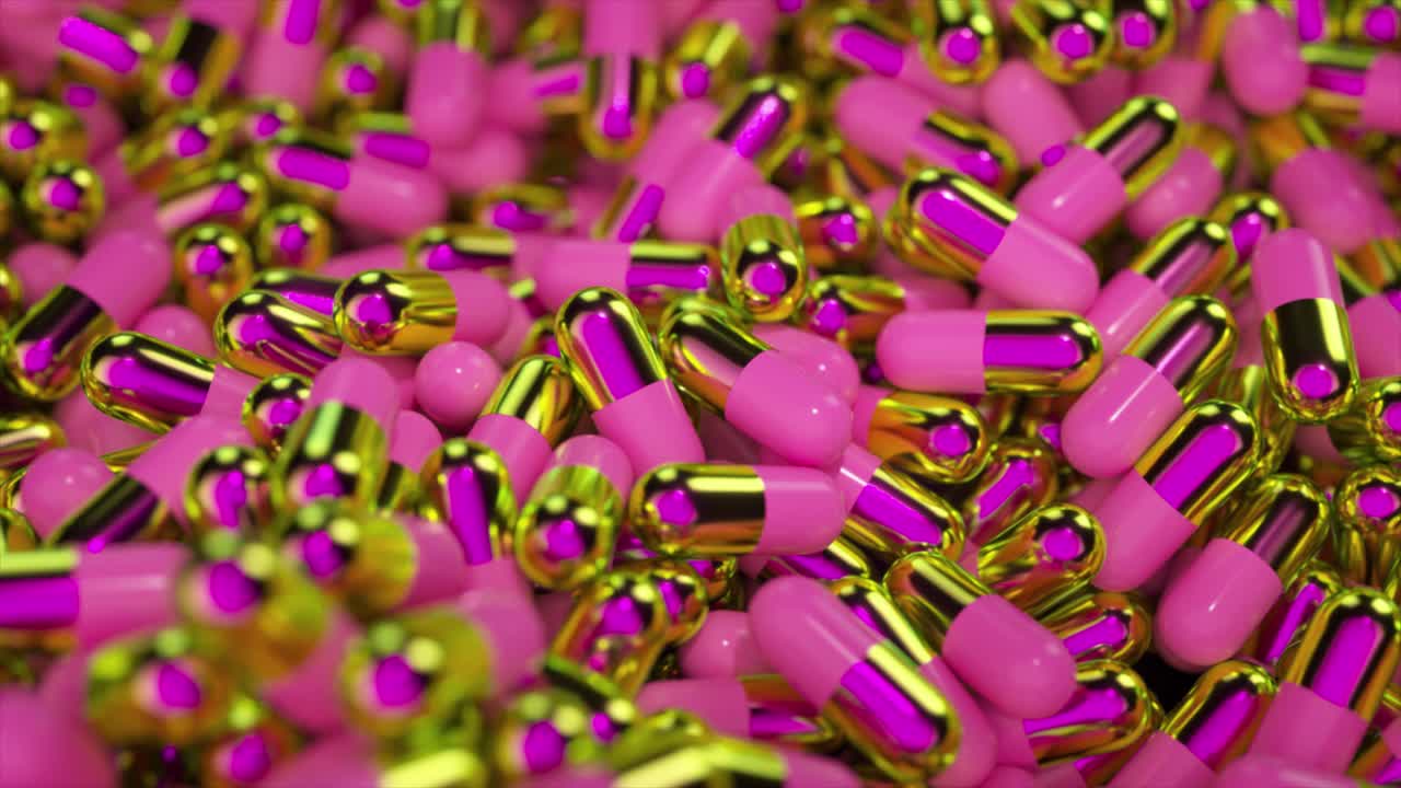 cápsulas de medicamentos rosas y doradas