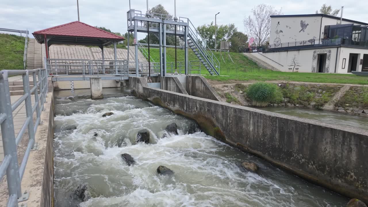 The gushing water through the entrance flood lock behind the dam of the Lake Tisza fish ladder in Kisköre, Hungary