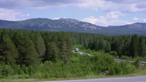 mountain road with forest and truck