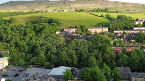 flying across todmorden town centre whilst panning up and zooming out and flying forwards multi axis shot of a beautiful rural town in england