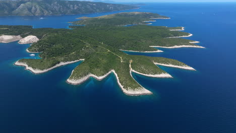 pakleni islands covered with green trees surrounded by blue sea in adriatic sea, croatia. - aerial shot