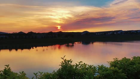 beautiful view of orange sunset reflect on the calming lake at recreation park