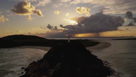 lighthouse on the beach at sunset