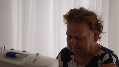grandmother using sewing machine for leisure time hobby