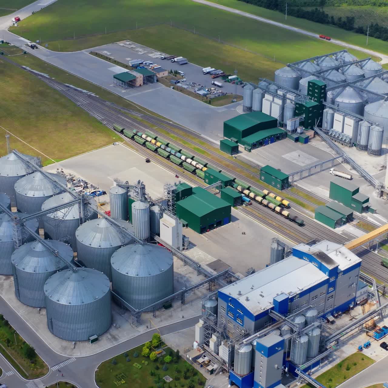 Big factory metal storages. Drone view of industrial grain elevator storages