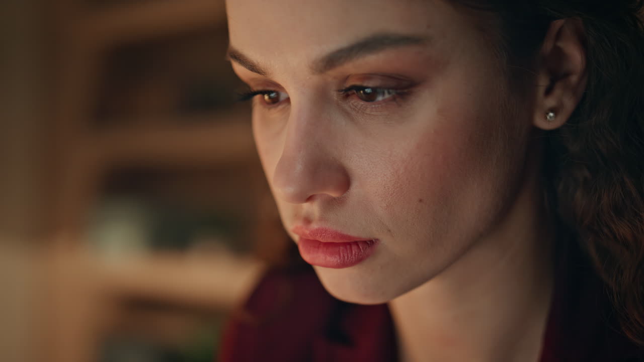 Closeup businesswoman working late looking laptop monitor. Serious woman manager