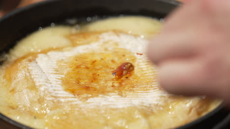 Placing-Cooked-Tomatoes-On-Top-Of-Provoleta