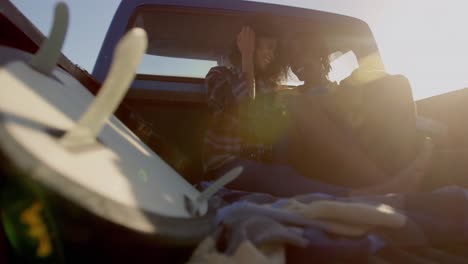 Couple-interacting-with-each-other-in-pickup-truck-at-beach-4k