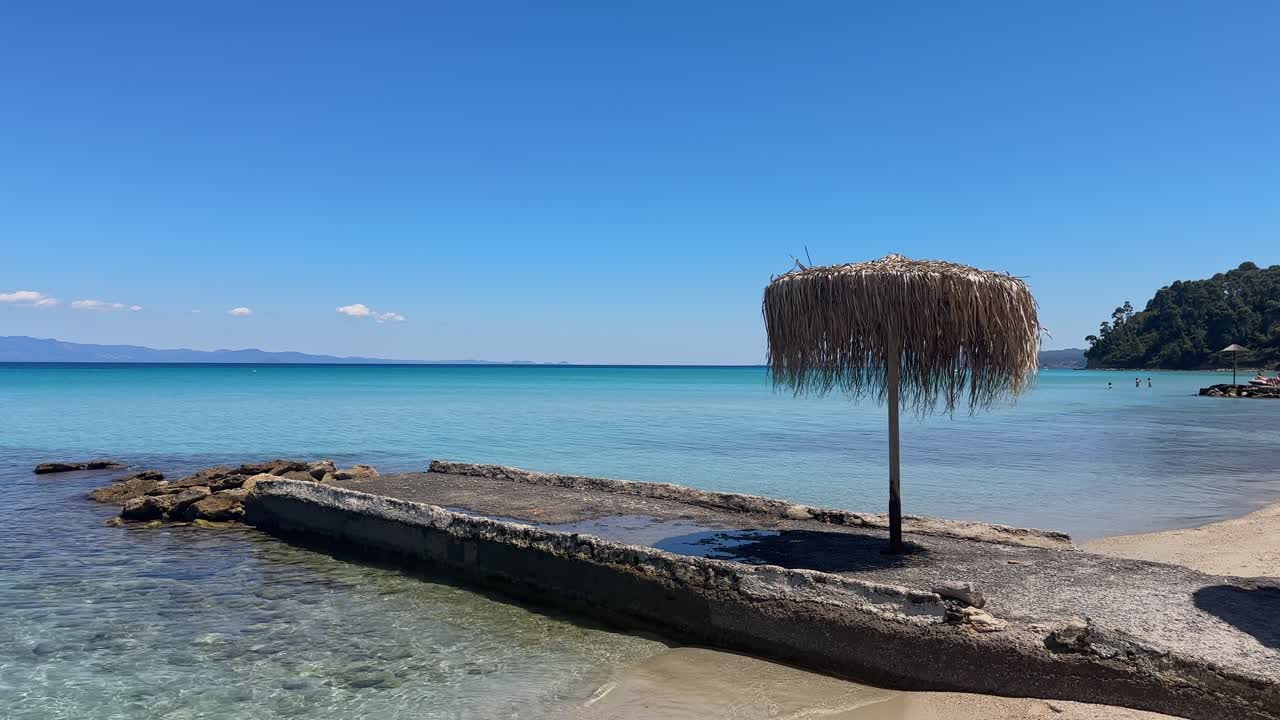 Stunning beach scene in Halkidiki, Greece, with elegant sunbeds facing the crystal-clear turquoise sea. A perfect summer escape in the heart of the Aegean.