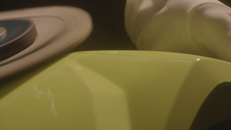 close-up of polishing machine buffing on a yellow car