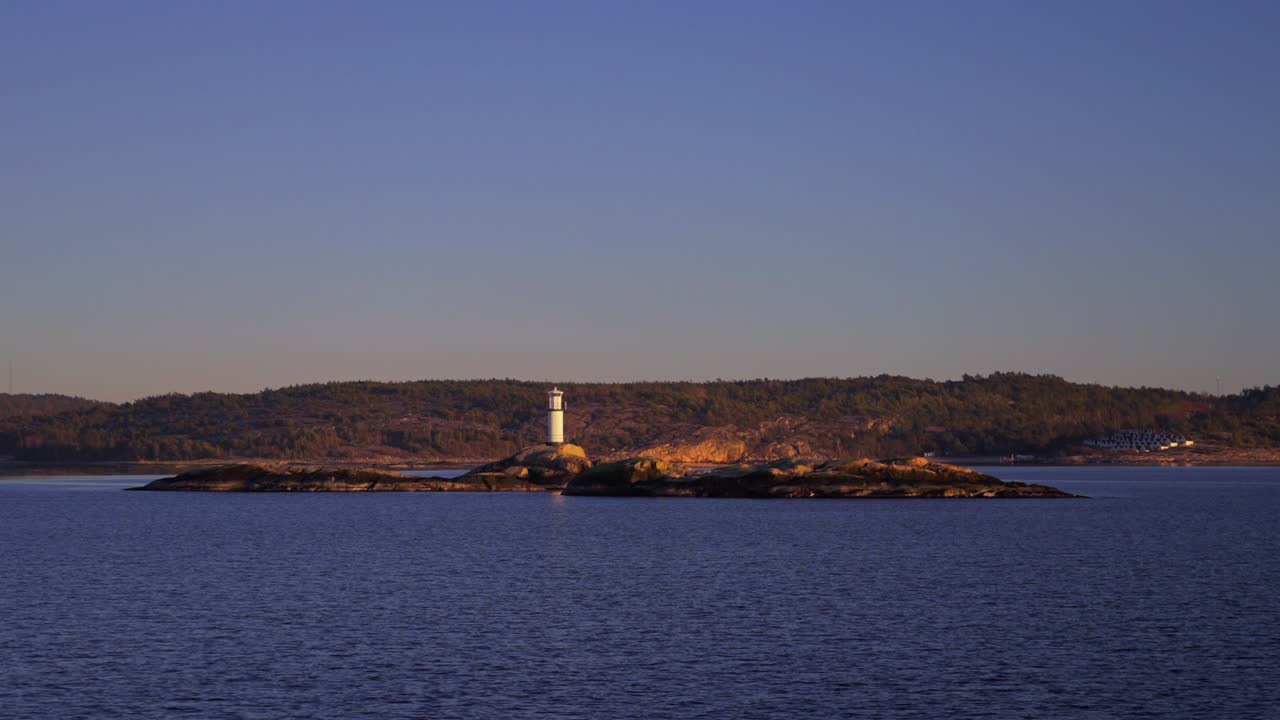 Ursholmen Lighthouse reflection golden hour winter Arctic sunlight sunset ferry boat ride Scandinavia islands Ytre Hvaler National Park Strömstad Stromstad Oslo Fjord Sweden Sverige Norway Norge