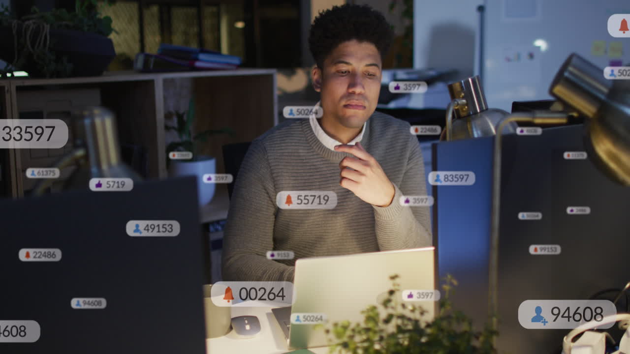 Animation of multiple notification bars over biracial man analyzing and preparing reports on laptop