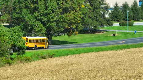 yellow school bus driving in rural usa