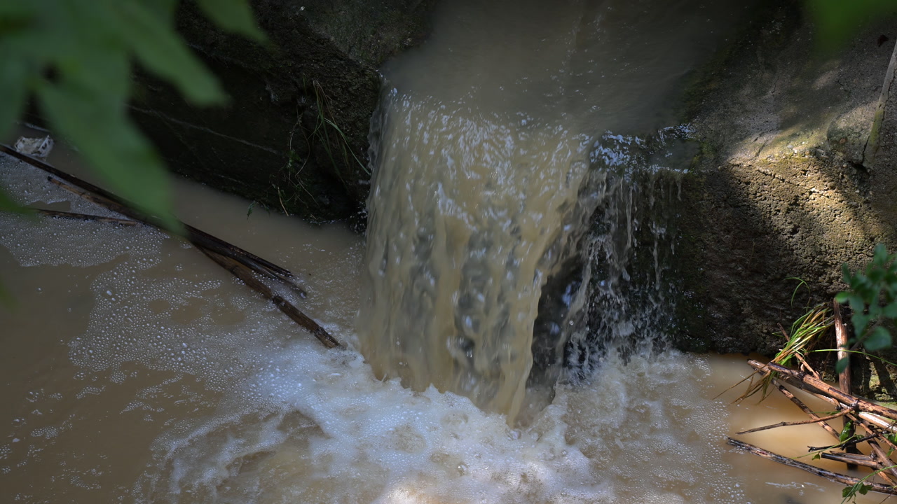 Polluted water flowing from drainage outlet