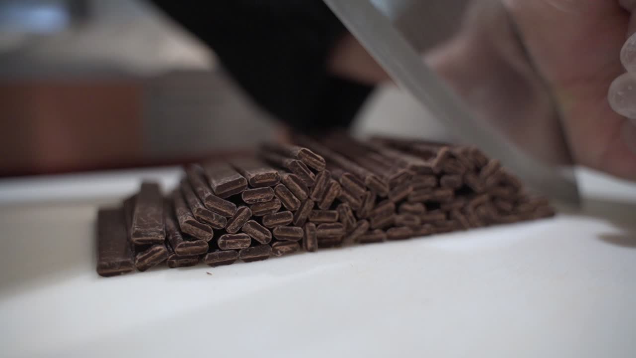 Cutting chocolate batons with a really sharp knife.