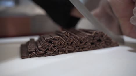 cutting chocolate batons with a really sharp knife.