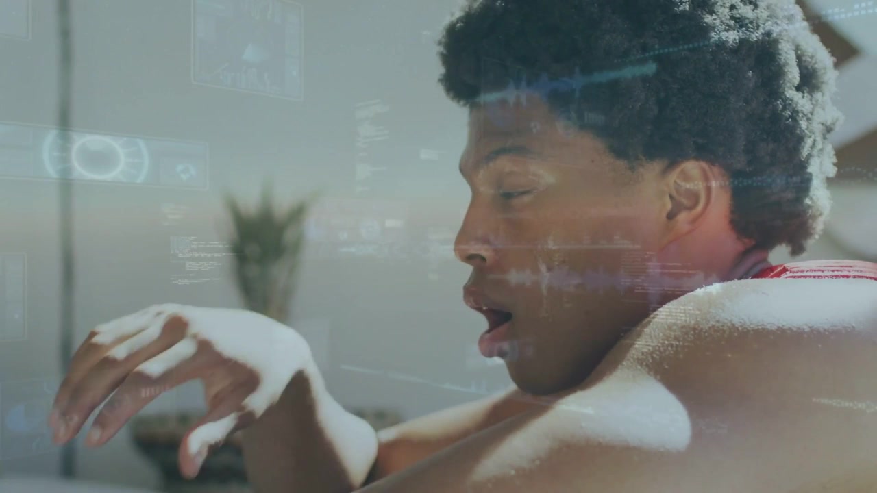 Man reacting to AR overlay, shifting from bowed to alert, lifting head, raising hand, engaging UI