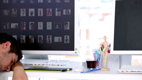 man sleeping in creative office